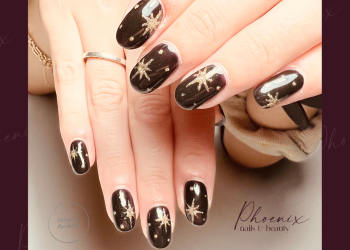 Black gel polish with gold hand painted stars on long natural nails