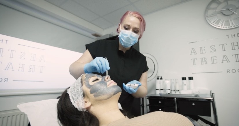 Dr Helen Whyte treating a patient with a face mask for acne